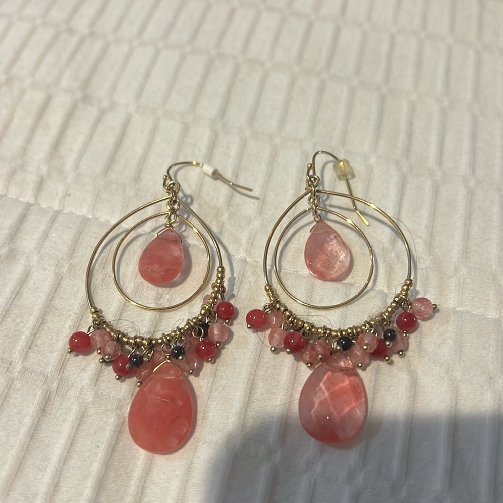 Hoop earrings with different colored orange and pink stones